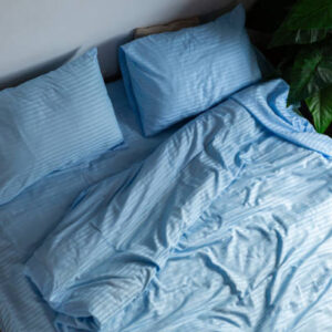 A messy minimal bedroom with an unmade bed