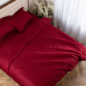 Red cotton bed satin linen on the bed morning messy