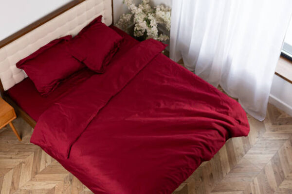 Red cotton bed satin linen on the bed morning messy