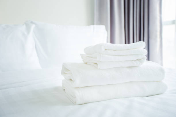 Stacked blankets on bed at home