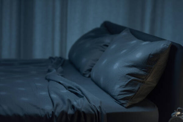 Contemporary clean bedroom interior with unmade bed, sleep and relax concept